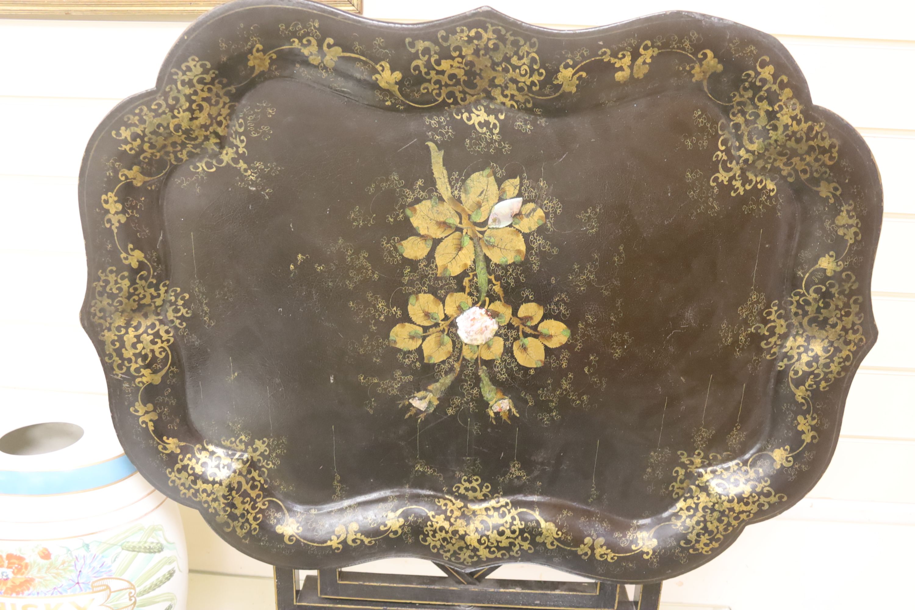 A large early Victorian papier mache tray on folding stand, 79 x 48cm, and a toleware tray